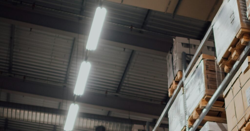 Warehouse racks holding palletized cartons for inventory replenishment planning