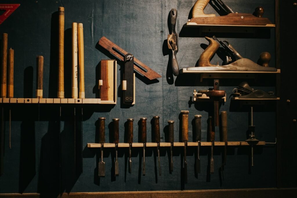 Hand tools arranged on a dark workshop wall
